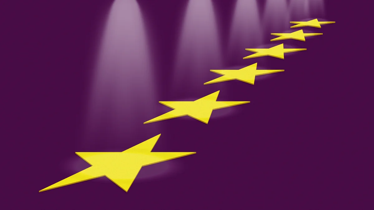 Gold stars rising against a purple spotlight