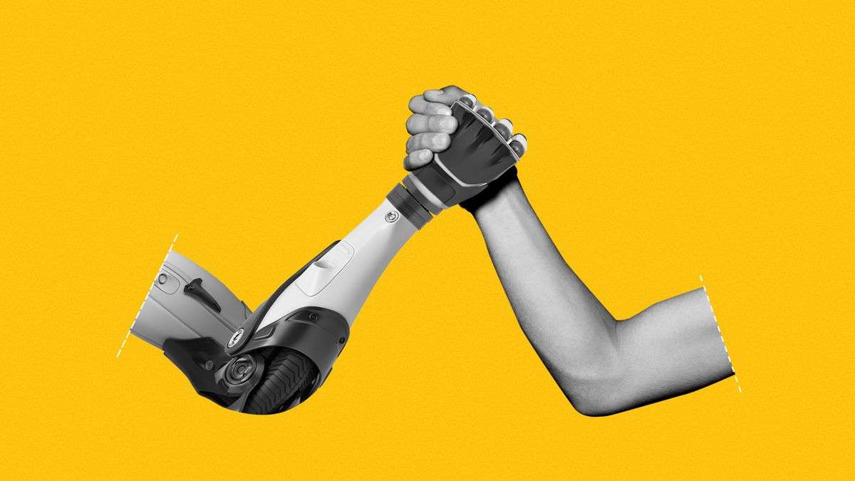 A bionic arm holding hands with a human arm