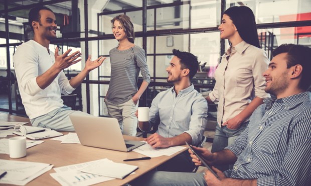 A team talking at a communal desk