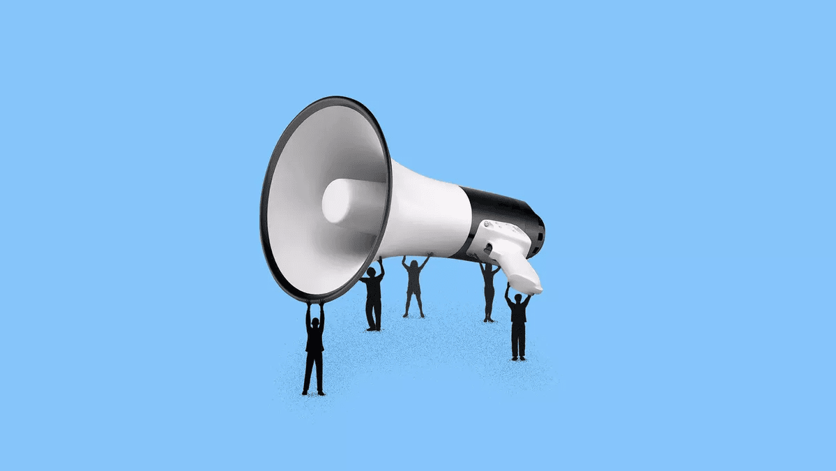 Five people holding up a large megaphone