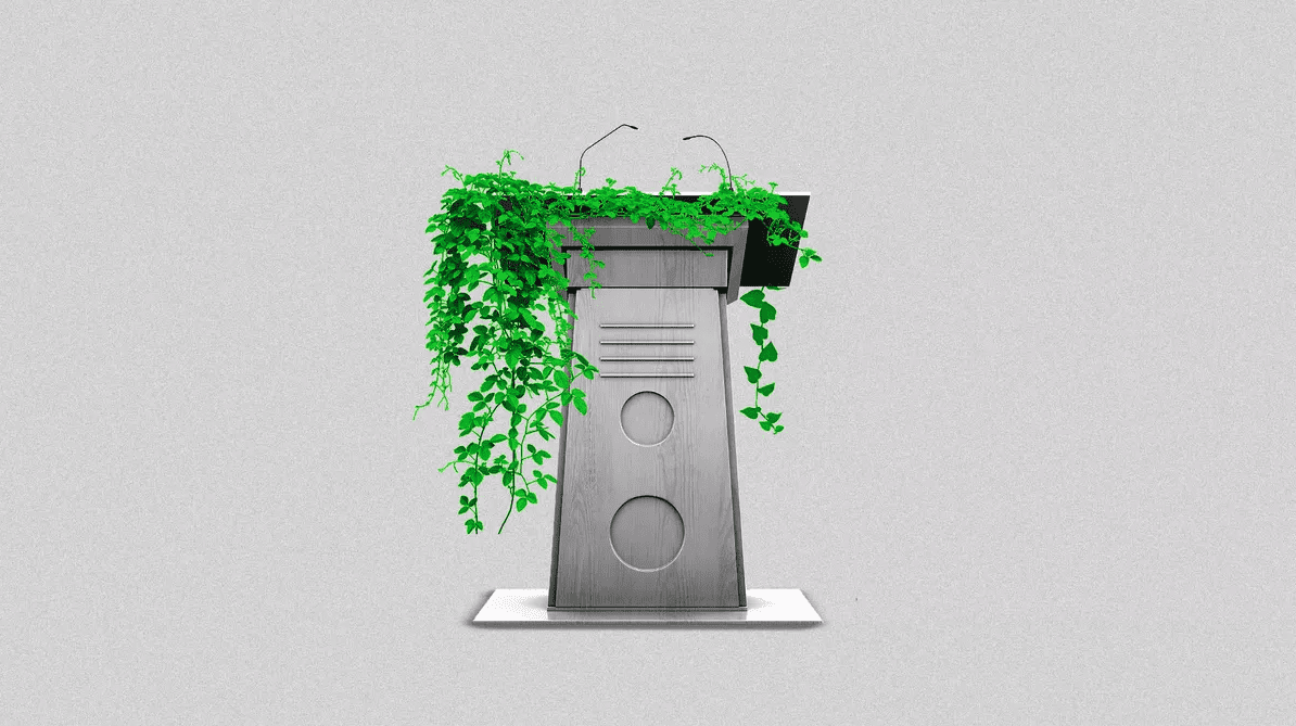 A podium with a green plant growing on it