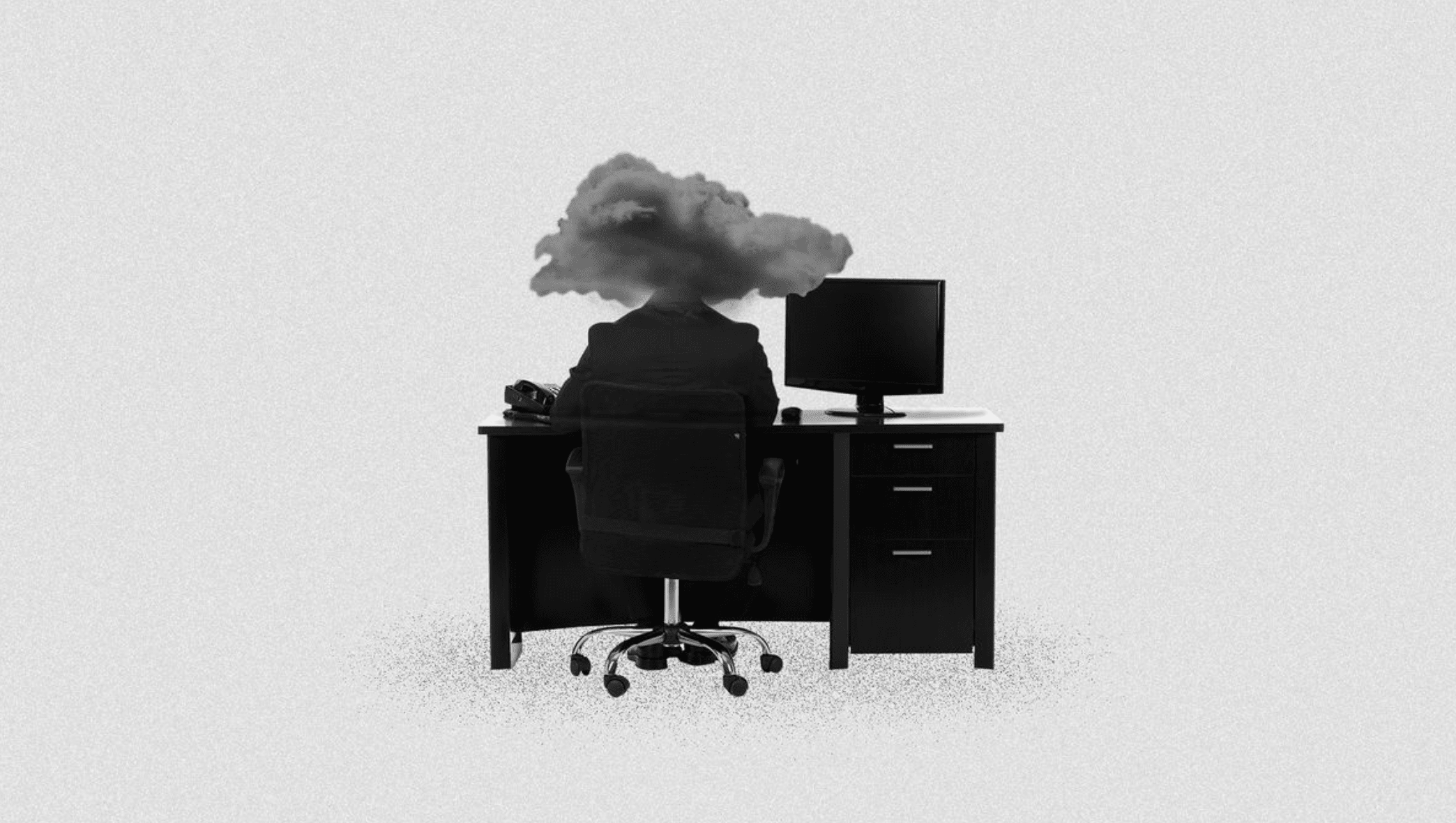 A person sitting at a desk with a cloud over their head