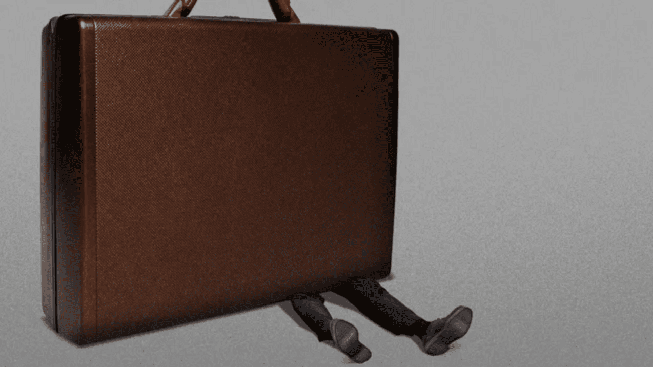 A business man being crushed by a large briefcase 