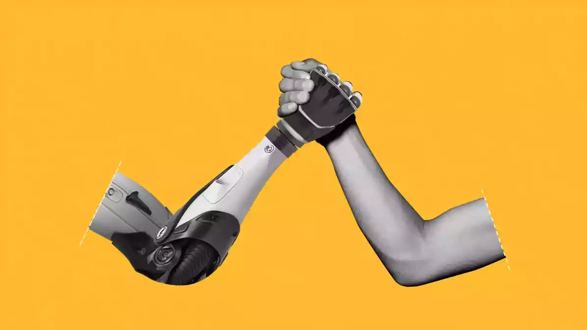 A robot arm and a person's arm holding hands triumphantly