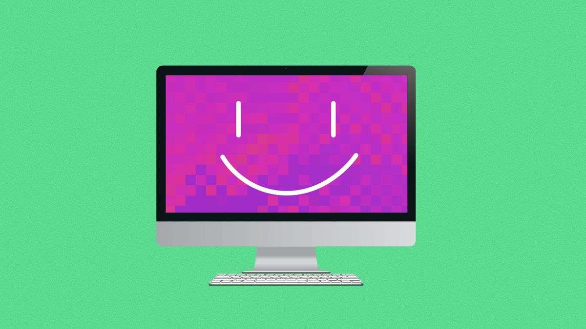 A computer monitor with a smile displayed on the screen